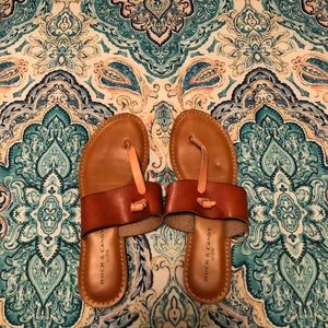 Tan and brown tied sandals.